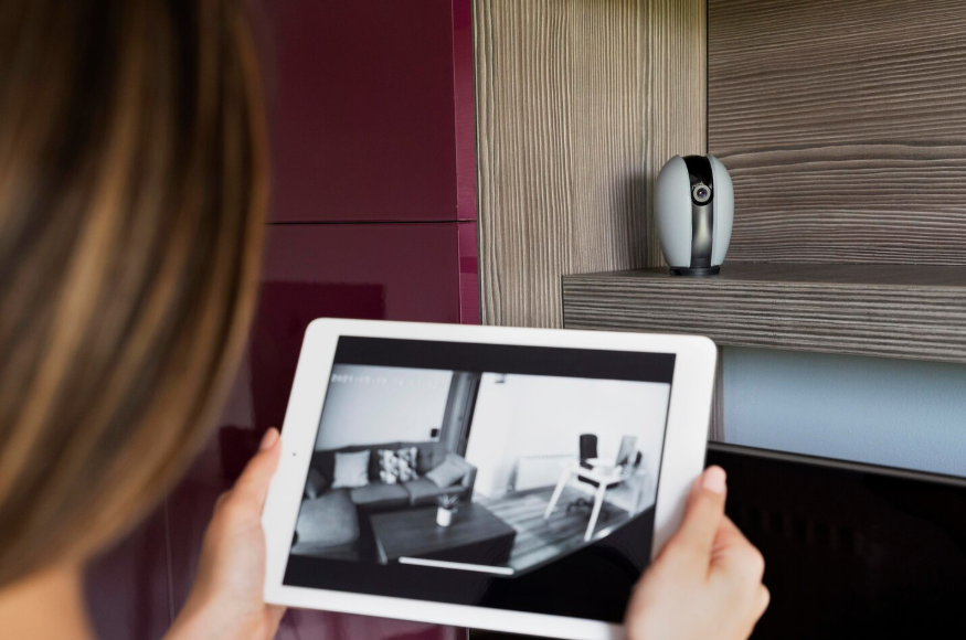 Tablet showing live feed explaining why home security cameras are trending.