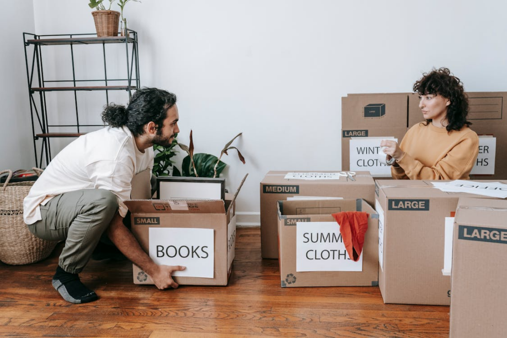 Couple packing boxes while deciding to downsize home.